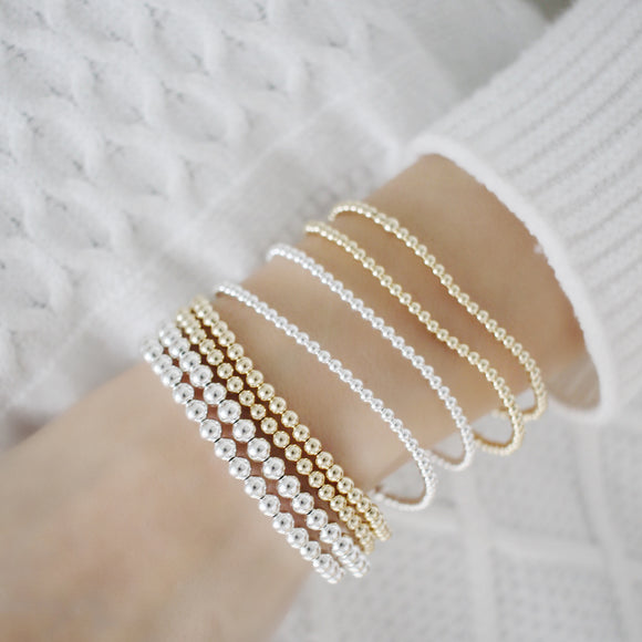 Our luxurious 14k gold bracelet is crafted with a delicate beaded design and stretchable elastic band for effortless comfort. Embellish your look with this stunning best seller bracelet for an elegant, timeless appeal.
