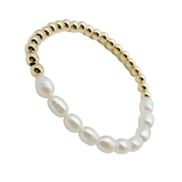 Dainty Gold stretch bracelet. Made with 14k gold filled 5mm beads and fresh water pearls. Great to wear alone or layered with other beaded bracelets. Bracelet measuring about 7 inches 