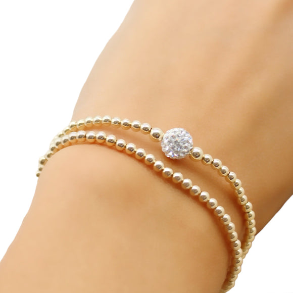 Dainty Gold stretch bracelet. Made with 14k gold filled 3mm beads with a beautiful sparkly pave bead ball. Great to wear alone or layered with other beaded bracelets. 