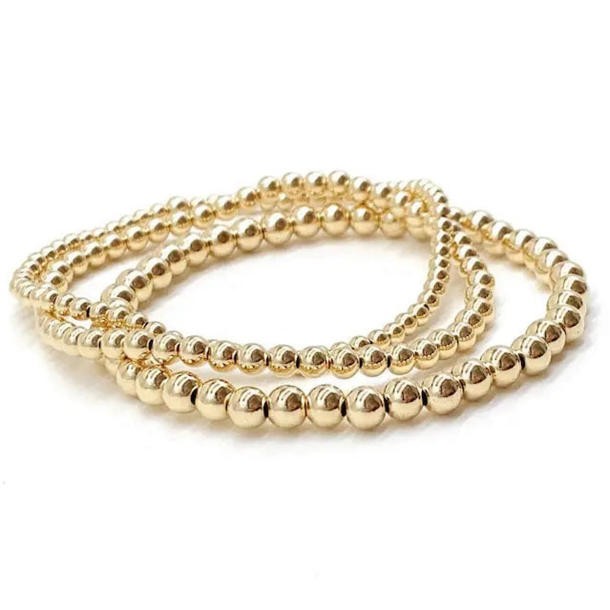 Three gold beaded stretch bracelets coiled together on a white background.