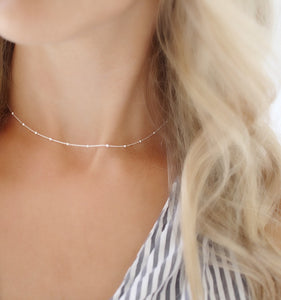 This Silver Choker Necklace adds a touch of sophistication to any look. Crafted from silver, its minimal and elegant design complements any outfit. Luxurious, timeless, and chic, this necklace is for those who appreciate fine jewellery.