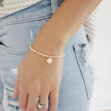 This elegant gold initial bracelet is a beautiful way to show off your unique style! Crafted with 14k Gold filled with minimalistic detailing, its chic design can be personalized with an initial for a charming touch