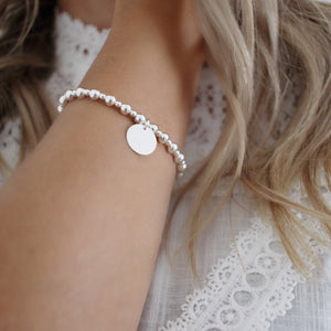 This elegant silver bead bracelet offers a delicate and stylish addition to any woman's jewelry collection. Crafted from sterling silver with a classic design, this bracelet provides a timeless and classic look for any occasion.