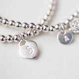 This beautiful silver initial bracelet brings a unique and personal touch to any outfit. Show your personality and style with its modern design, featuring a single initial of your choice. Wear it alone for a subtle statement or layer with other bracelets for an effortless style. A perfect gift for any occasion.